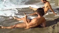 Two gay friends stroking at the beach Thumb